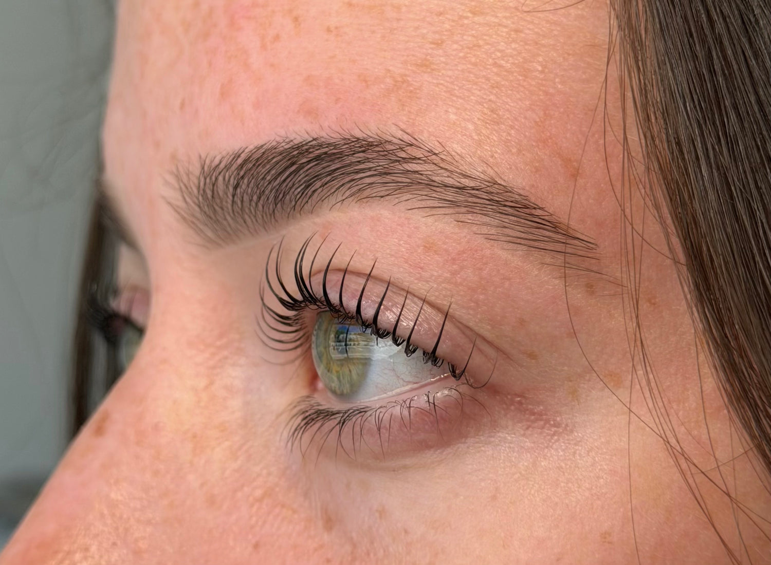 Close-up of a person's eye with long eyelashes after Korean Lash Lift