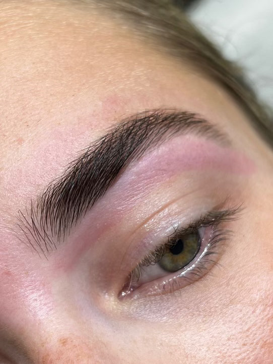 Close-up of a person's eye with well-groomed eyebrow