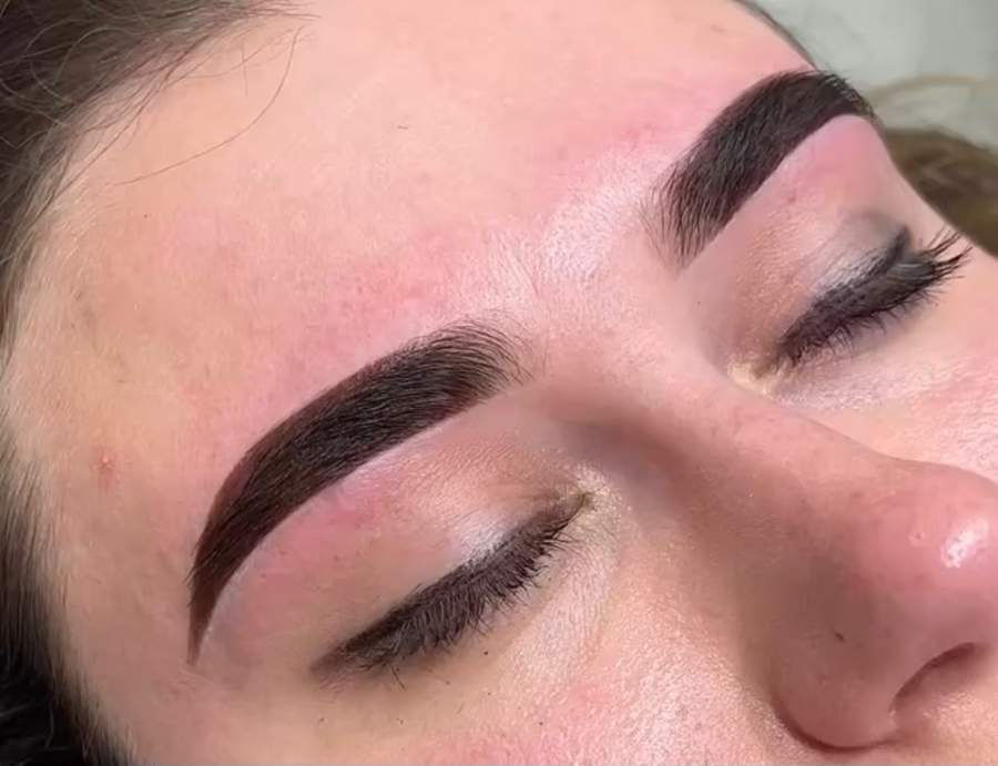 Close-up of a person's face with well-groomed eyebrows and eyelashes.