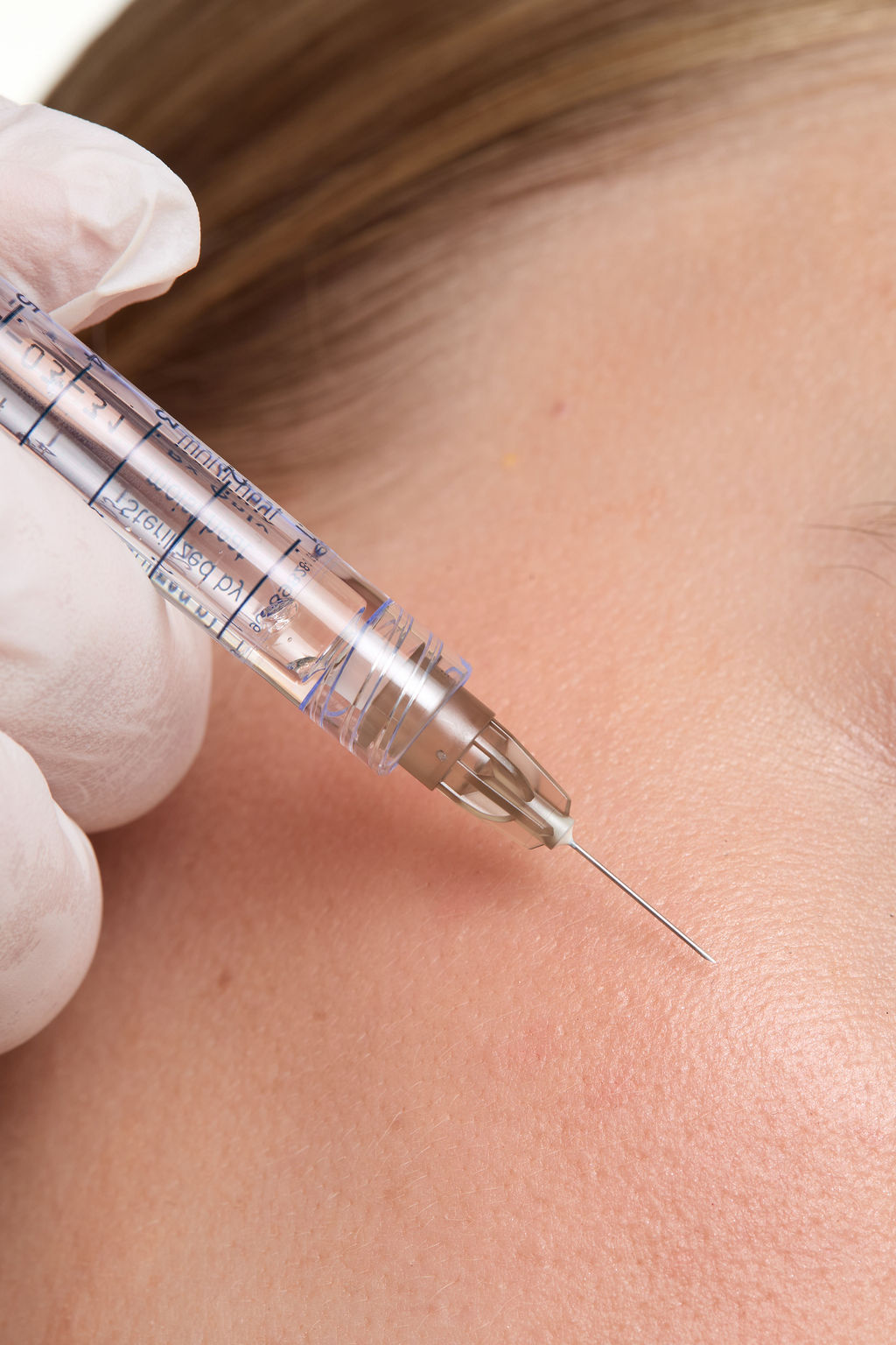 Close-up of a person receiving an injection with a syringe.