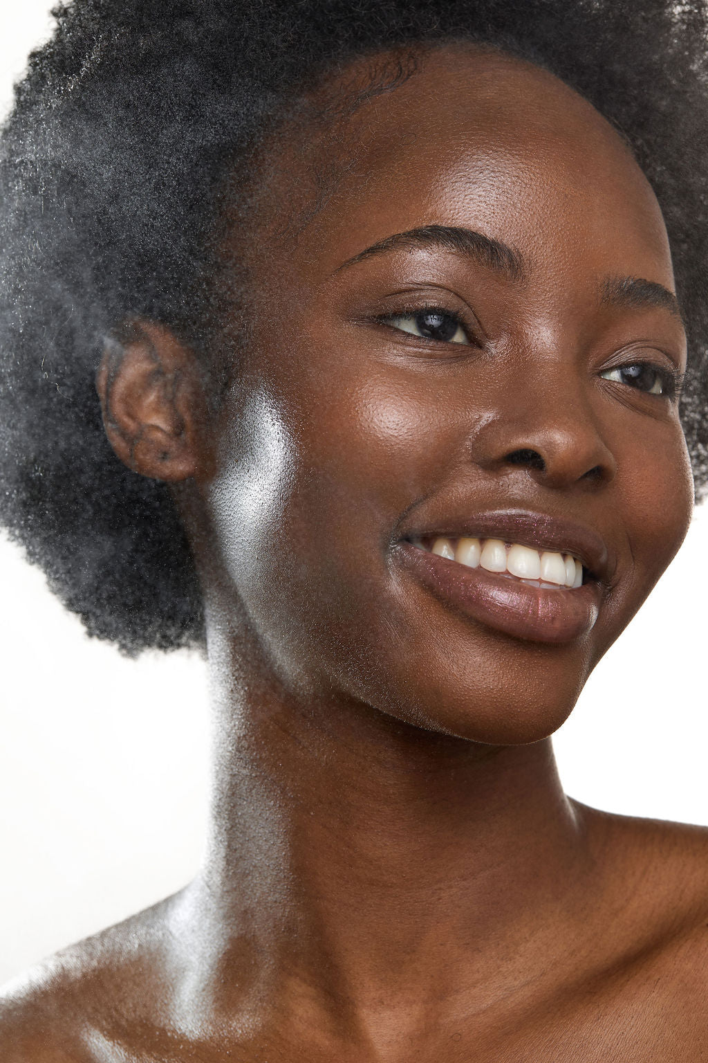 Close-up of a woman with a soft smile on a white background